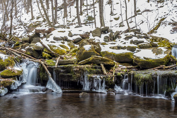 Small frozen waterfalls in winter Catskill mountains