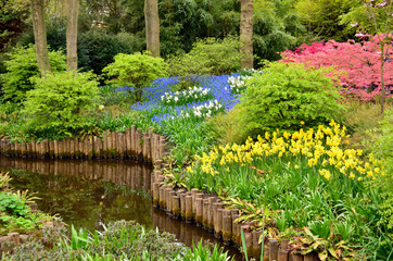 Flower bed in Keukenhof on the bank of the pond