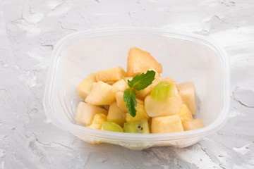 green apple and mint leaf salad with condensed milk in food container