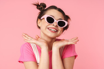 Photo of joyful charming girl in sunglasses posing and laughing