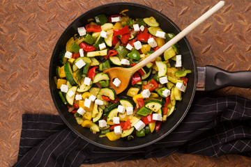 Cooked roasted vegetables in pan.