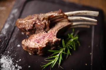 Grilled lamb chops served with a branch of rosemary