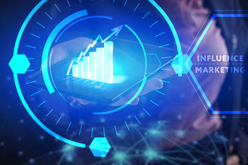 Business, Technology, Internet and network concept. Young businessman working on a virtual screen of the future and sees the inscription: Influence marketing