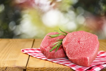 Fresh raw meat steaks on desk