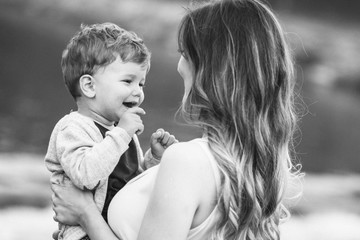 Mom holding her son, looking at him. Black and white photo. Mothers day © stivog