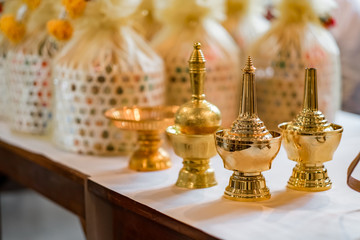 Fototapeta na wymiar Water in a golden bottle buddha Prepare to share the happiness of Thai wedding traditions.