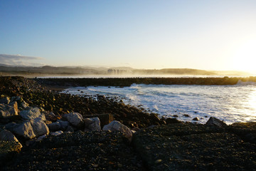 sunset on coast of sea