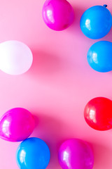 Decorative frame with colorful balloons on pink background top-down frame copy space