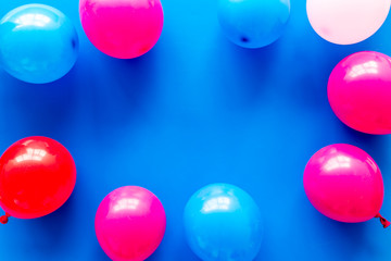 Decorative frame with colorful balloons on blue background top-down frame copy space