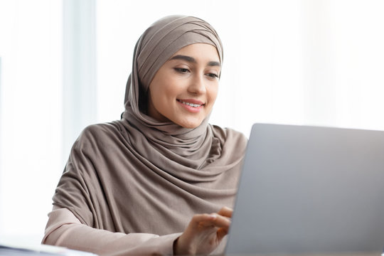 Closeup Portrait Of Saudi Businesswoman Working On Laptop Computer In Office