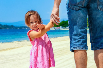 beautiful hands of parent and child by the sea