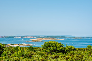 Stunning Adriatic coastline,campsite with rocky beach, scattered small islands and many boats and sailing yachts in the blue waters of the Adriatic, Cape Kamenjak, Istria, Croatia.