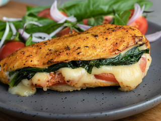 Baked chicken fillet stuffed with spinach, tomatoes and cheese