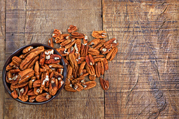 Bowl with pecan on rustic wooden table