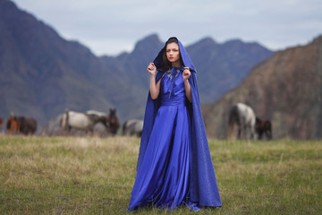 A girl walks in the mountains.