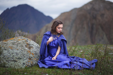 A girl walks in the mountains.