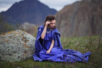 A girl walks in the mountains.