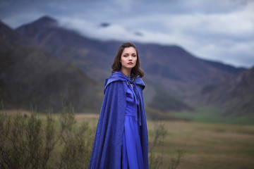 A girl walks in the mountains.