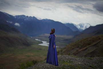 A girl walks in the mountains.