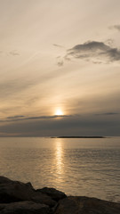 Emotional shot of a bay at sunrise or sunset in backlight with very cloudy sky