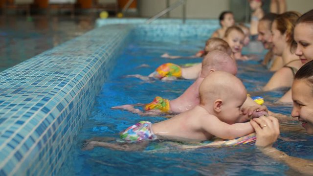 Group of mothers with children in the pool