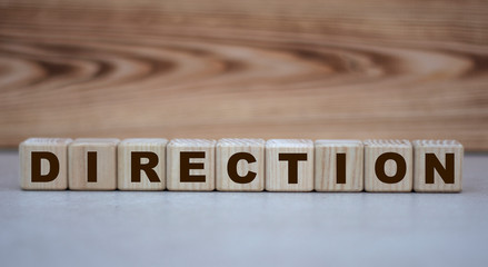 concept word direction on cubes on a beautiful wooden background