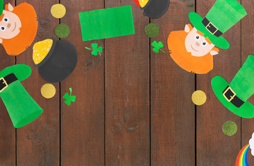 holidays and celebration concept - st patrick's day decorations or party props made of paper on...