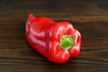 Organically grown ugly red pepper from local farmers market. High resolution, dark wood background