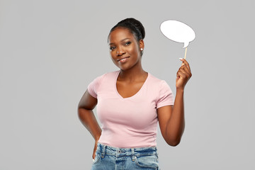 party props, photo booth and communication concept - happy african american young woman holding blank speech bubble over grey background