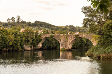 Fototapeta na wymiar Oruna de Pielagos, Spain. The Puente Viejo (Old Bridge) over the river Pas in Cantabria
