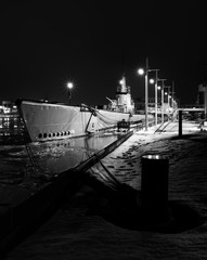 Submarine at dock in the winter - 324271602