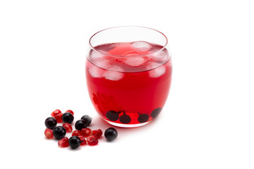 Compote pomegranate berries and blackcurrant in a glass on a white isolated background