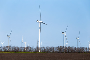 Wind turbines on an autumn or spring field