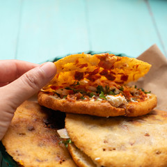 Mexican gorditas with pressed chicharron on turquoise background