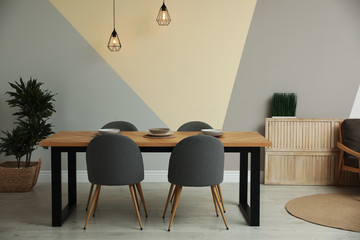 Modern wooden dining table in room interior