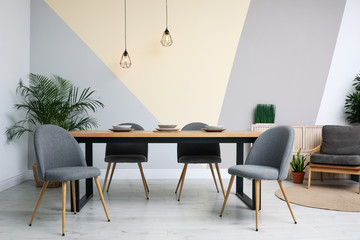 Modern wooden dining table in room interior