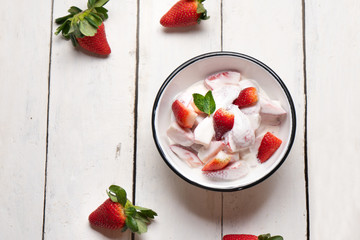 Strawberries and cream dessert on white background