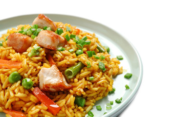 Delicious rice pilaf with chicken and vegetables on white background, closeup