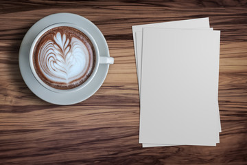 Blank paper and a cup of hot Espresso coffee with beautiful latte art on the wodden table