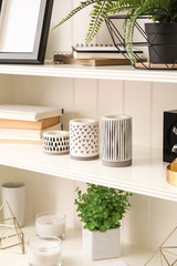 White shelving unit with different decorative stuff
