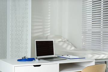 Fototapeta na wymiar Doctor's workplace with laptop in modern clinic