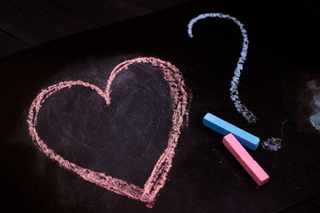 Heart with a question mark on a black background.