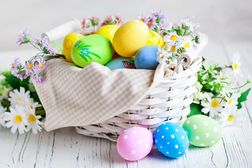 Fototapeta premium Happy Easter. Congratulatory easter background. Easter eggs and flowers. Background with copy space. Selective focus.