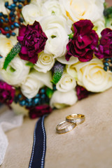 Wedding rings on a background of a bouquet of flowers
