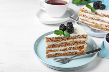 Tasty cake with berries on white wooden table