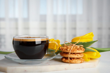 Aromatic morning coffee, cookies and beautiful flowers on white table