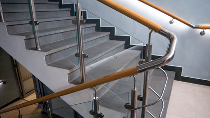 Stainless steel, glass and wood railing.Fall Protection. modern design of handrail and staircase