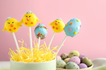 Delicious sweet cake pops on pink background, closeup. Easter holiday
