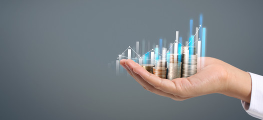 Coins stacked on each other in different positions. hand in business casual money
