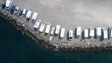  Top view of area with campers, caravans in parking near ocean. Lofoten, Norway.